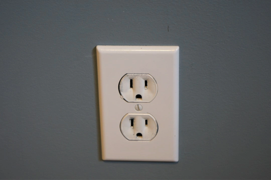 scorched electrical outlet plate showing signs of heat damage and arcing