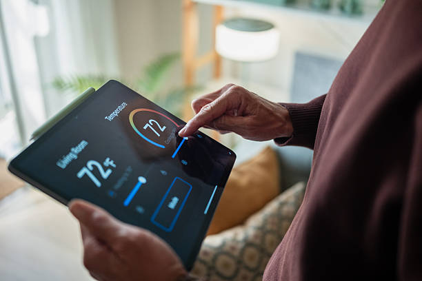 homeowner adjusting home temperature via smartphone homeowner adjusting home temperature via smartphone