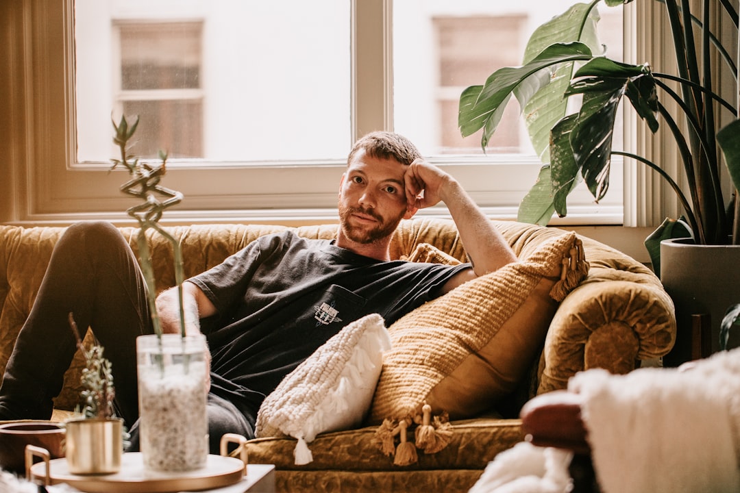 A homeowner looking relaxed in a well-lit living room during a storm outside