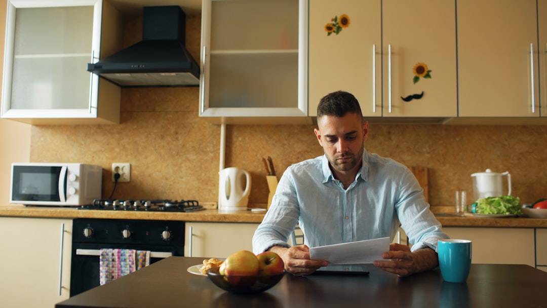 Homeowner reviewing system documentation to decide on HVAC repair vs replacement