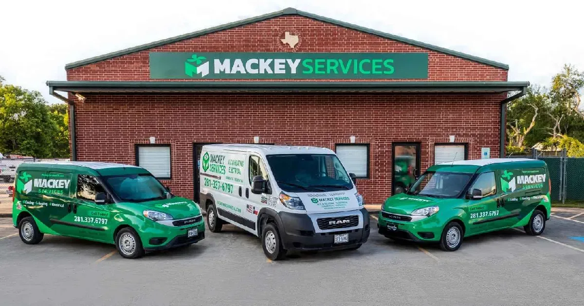 Mackey Services wrapped green service vans lined up at the Dickinson headquarters