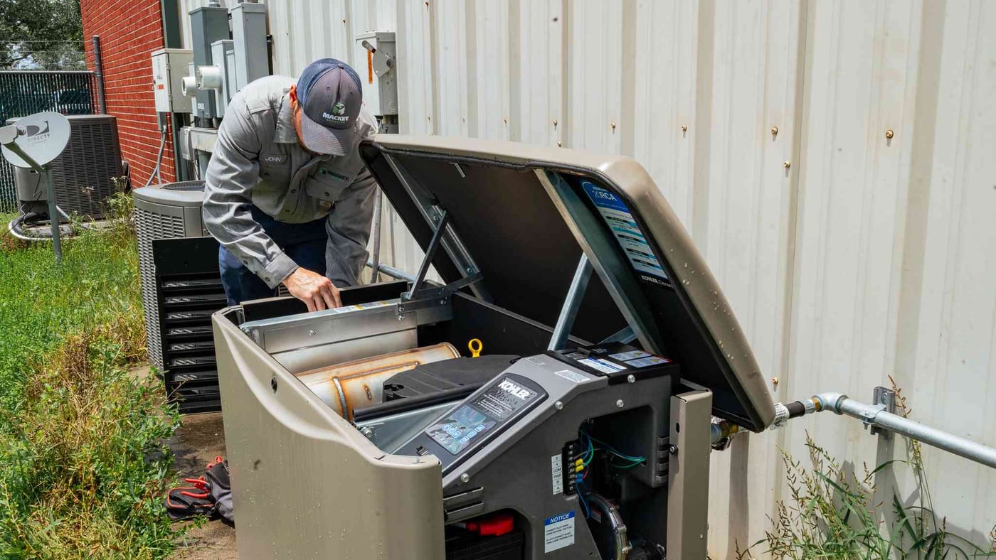 Mackey Services technician servicing a whole-home standby generator